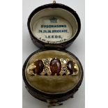 A 22 carat gold ring set with garnets and diamonds in original presentation box. Weight 3.6gm.