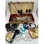 A quantity of vintage costume jewellery to include watches, bead necklaces and bangles etc.