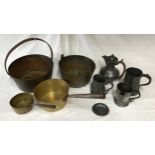 A collection of brass, copper and pewter to include two copper pans, two brass buckets and pewter