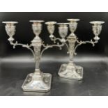 A pair of good quality late 19thC silverplated twin branch candelabras with square bases decorated