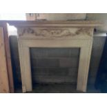 A well carved pine fire surround. Internal 95w x 95cm h, external 157w x 141xm h. By Douglas