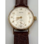 A Vertex 9ct gold cased wristwatch with subsidiary seconds dial and brown leather strap. Winds and