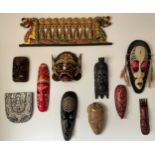 Eleven various wooden wall masks, dragon boat 96 w x 30cm h. One resin.