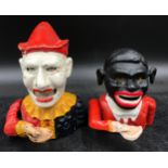Two cast iron, hand painted, articulated ‘man eating money’ money boxes tallest 18cm h.