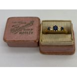 An 18 carat gold ring set with diamonds and sapphires in original presentation box. Weight 2.9gm.