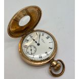 A half hunter 10 carat gold plated Waltham pocket watch. Winds and goes.