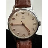 A Tudor vintage wristwatch on brown leather strap on Rolex stainless steel case. 32mm case. Winds