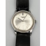 A 1970's Longines manual wristwatch with silver face and leather strap. Winds and goes. Very good