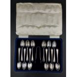 Boxed set of twelve silver teaspoons and a pair of sugar tongs dated 1915 by Cooper Brothers & Sons,