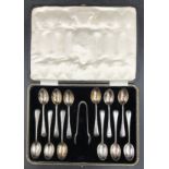 A boxed set of 12 initialled silver teaspoons and sugar tongs Sheffield 1930 by Francis Howard Ltd