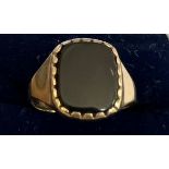 A 9 carat gold ring set with black stone. size P. Weight 2.5gm.