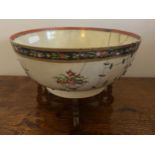 An 18thC porcelain punch bowl 26cm d together with later wooden display stand. Purported to have