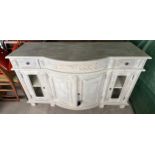 A white painted sideboard with double doors flanked by glazed doors and 2 drawers to top 152w x