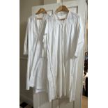 Two early 20thC cotton nightgowns and two small table cloths. Longest nightgown 120cm.
