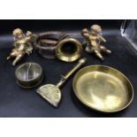 A collection of brass items to include a pair of matching cherubs, horn wrapped in leather, back