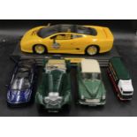 A collection of toy cars to include a Maisto jaguar XJ220 racing on stand, another smaller Maisto