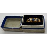 An 18 carat gold ring set with sapphires and diamonds. Weight 3.5gm. Size R/S. In original
