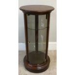 A reproduction mahogany drum design display cabinet, all round glazed panels with single door and