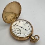 A nine carat gold Waltham hunter pocket watch with white enamel dial and subsidiary second dial.