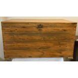A pine box with metal handles and hinged lid on chain measuring 54cm h x 99cm l.