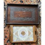 Two hardwood trays, one carved and one inlaid with butterfly wings. Largest 64 x 41cm without