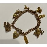 A 9 carat gold bracelet with eight charms of 9, 14 and 18 carat. Total weight 47gm.