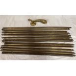 A collection of 13 brass stair rods along with a novelty brass door knock in the shape of a fish.