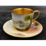 A Royal Worcester Raymond Rushton coffee cup and saucer painted with castles by a river