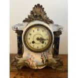 A French painted porcelain mantle clock with white enamel and floral decorated face. 27cm h.