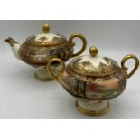 A Nippon hand painted moriage teapot and lidded sucrier.