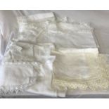 A small collection of linen to include two table cloths, two tray covers and some doilies.