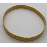 A 21 carat gold bangle marked 875. Weight 20.3gm.