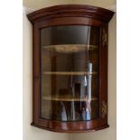 A 19thC mahogany single door corner cabinet with single glazed convex door. 89cm h.