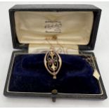 An Edwardian 9 carat gold pendant on fine gold chain set with garnets. Total weight 1.6gm together