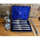 Silver to include a pair of weighted candlesticks, Birmingham 1920, mother of pearl handled fork,
