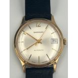 A 9ct gold cased Garrard automatic date wristwatch with leather strap. Winds and goes. Very good