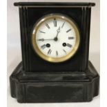 A late 19th century polished slate mantel clock, with an 8 day movement striking on a bell,