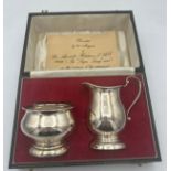 A cased silver milk and sugar bowl Birmingham 1971/72, maker A.T. Cannon Ltd. Total weight 153.6gm.