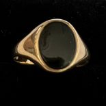 A 9 carat gold ring set with oval black stone, size N, weight 1.7gm.