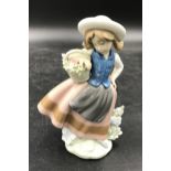 A Lladro figure of a girl with pigtails holding flower basket entitled Linda con cesta in original