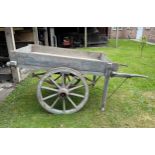 A 19thC hand cart with wooden wheels and steel rims and suspension. Originally used to transport