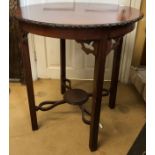 A Edwardian circular mahogany occasional table with carved patterned edge 73h x 65cm d.