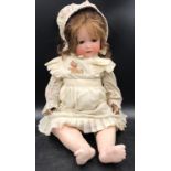 A Melitta German doll marked 12 to back of head with blue lashed sleeping eyes 64cm h.