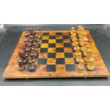 A wooden chess set with complete pieces made by Masenghini Bergamo.