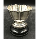 A silver cup on wooden stand, hallmarked Birmingham S Blanckensee & Son Ltd. Total silver weight