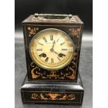 A wooden cased mantle clock with 8 day movement marked Charles A Paris to face, back panel is marked