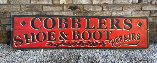 A colourful wooden advertising sign for “ Cobblers Shoe & Boot Repairs”. 150cm l x 37.5cm w.