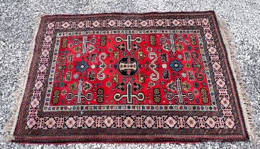 A vintage ground wool rug. 133 x 196cm.