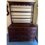 An 18thC oak dresser comprising four drawers and one cupboard with rack to back. 125cm w x 45d x