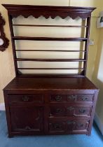An 18thC oak dresser comprising four drawers and one cupboard with rack to back. 125cm w x 45d x